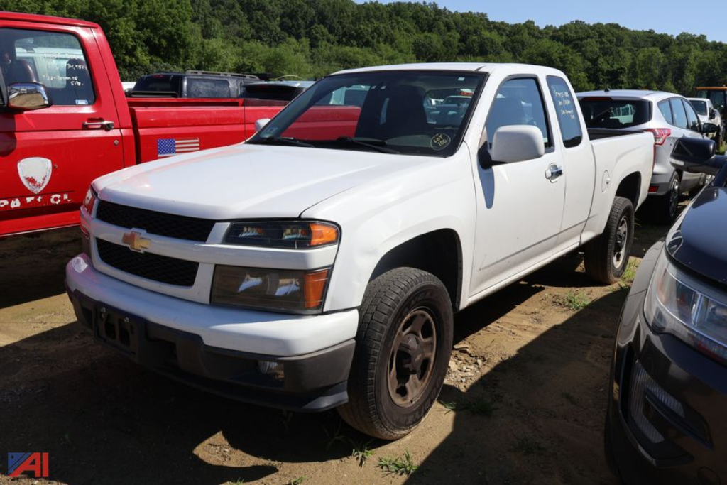 Chevrolet Colorado pickup truck in white, front three-quarter view, parked in a lot with other vehicles.