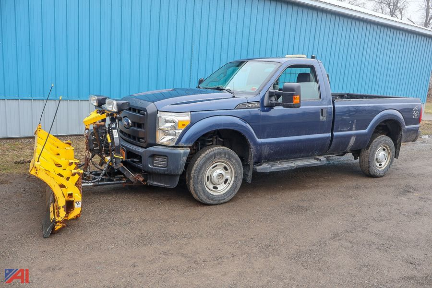 Ford F-350 Super Duty pickup with snow plow attachment in front, dark blue exterior, extended cab, 4x4, side view.