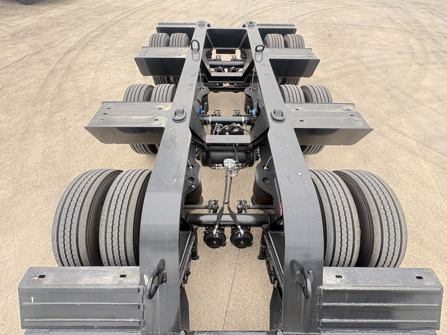 Load King lowboy trailer chassis showing dual axles and fifth-wheel connection, no visible branding text on components.