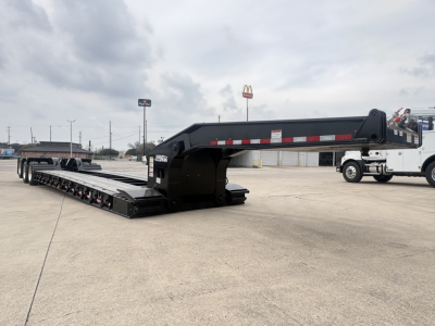 Load King lowboy trailer in transport position showing main deck and gooseneck with reflective tape.