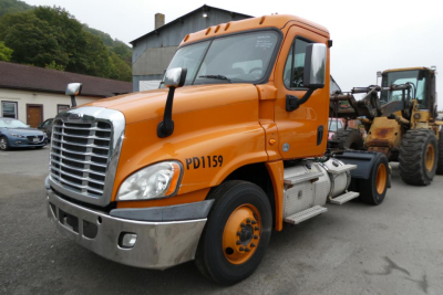 Freightliner Cascadia 125 truck cab with orange paint, front grille, and PD1159 marking on door; side view shows chrome bumper, mirrors, and fuel tanks.