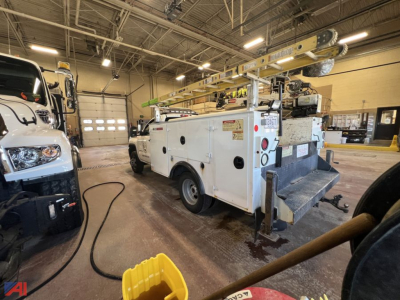 GMC Sierra 3500HD utility truck with crane in a shop, service utility category.