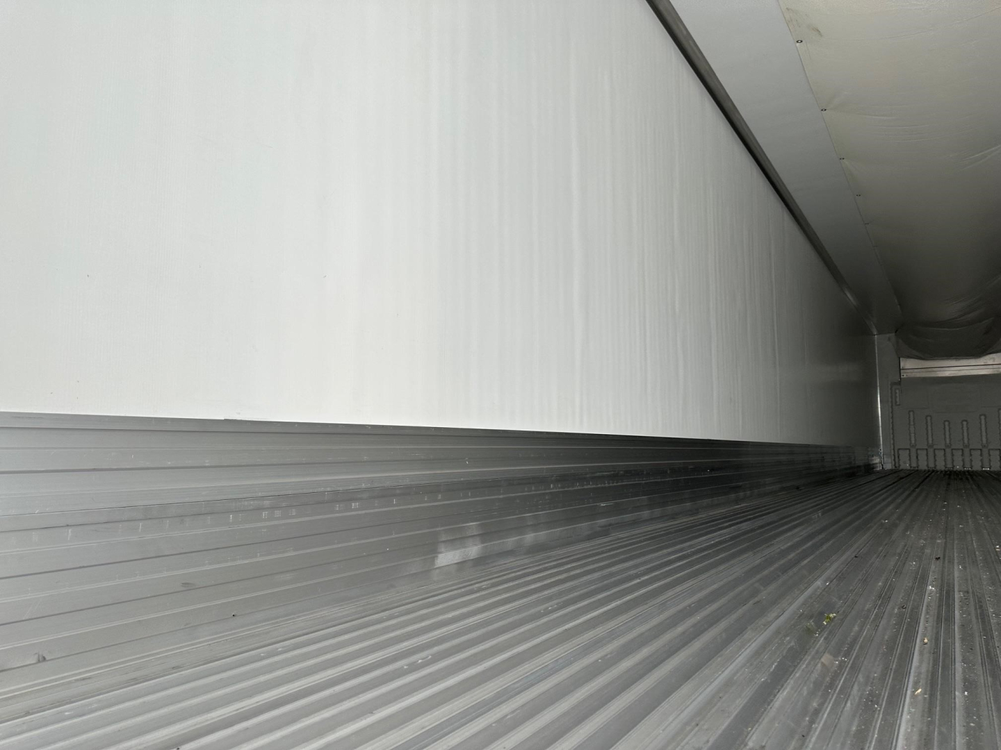 Trailer interior cargo area showing ribbed floor and side walls in a refrigerated trailer.