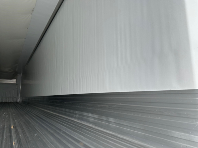 Trailer interior showing smooth metal wall panels and ribbed floor of a 2026 Utility 3000R reefer trailer with aluminum walls.