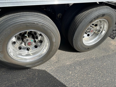 Trailer axle wheels showing dual rear tires and chrome rims on a new Utility 3000R reefer trailer.