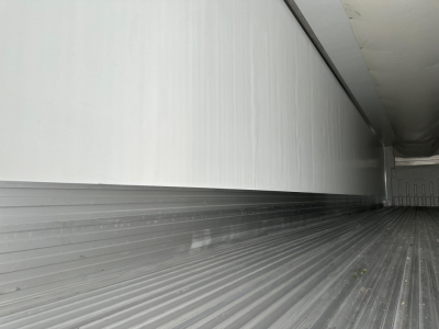Trailer interior cargo area showing ribbed floor and side walls in a refrigerated trailer.