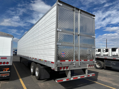 Trailer rear view with diamond plate doors, silver ribbed sides, dual rear doors, and standard taillights on a utility trailer.