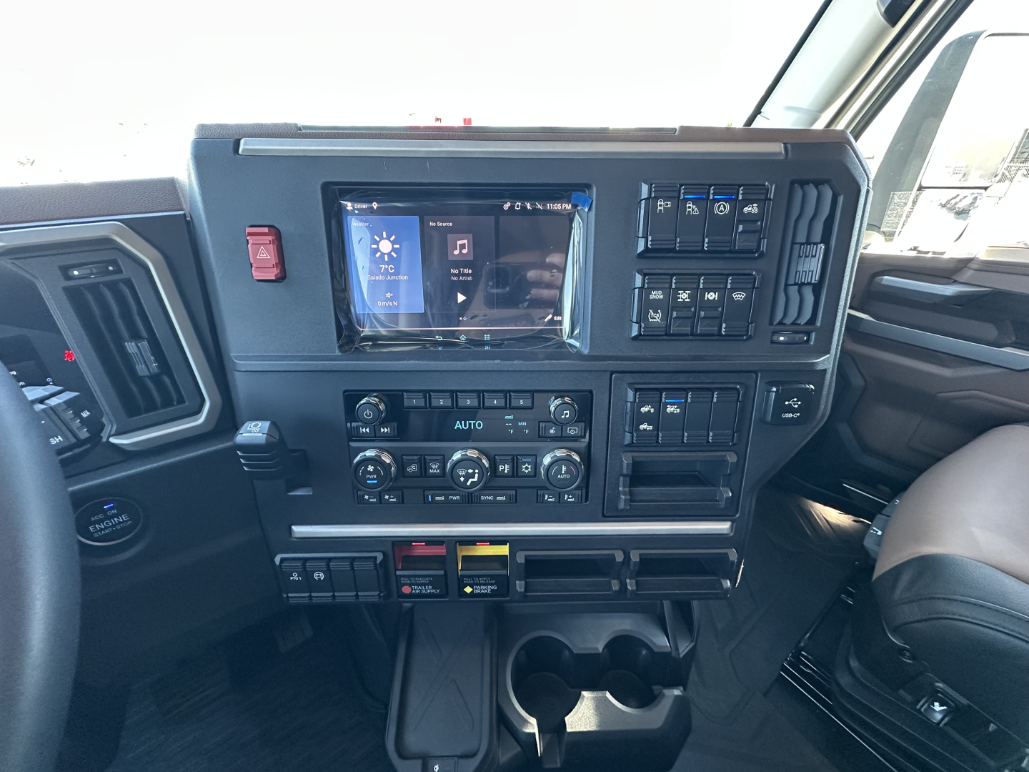 Mack PR64T64 cab interior showing dashboard with touchscreen display and climate controls.