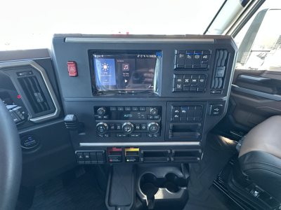 Mack PR64T64 cab interior showing dashboard with touchscreen display and climate controls.