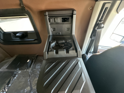 Cab interior of a 2026 Mack PR64T64 showing center console with cup holders and control panel.