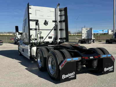 Truck rear view showing fifth wheel area and dual rear axles with mud flaps displaying Buckner Equipment logos.