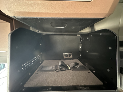 Mack PR64T64 sleeper cab interior storage compartment showing empty cargo area with wiring harness in the floor and side panels.