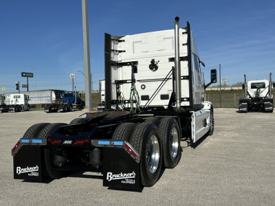 Back of a white Mack PR64T64 tractor with dual rear axles, mudflaps labeled "Bruckner's