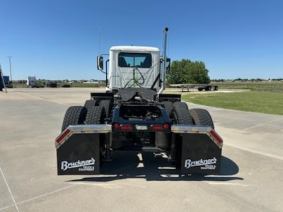 Mack AN64T tractor rear view showing dual rear wheel assembly and handicap mudflaps with Buckner's Equipment branding.