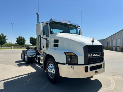Mack AN64T conventional daycab truck in white with chrome bumper and grille, side view showing dual rear axles and large mirrors.