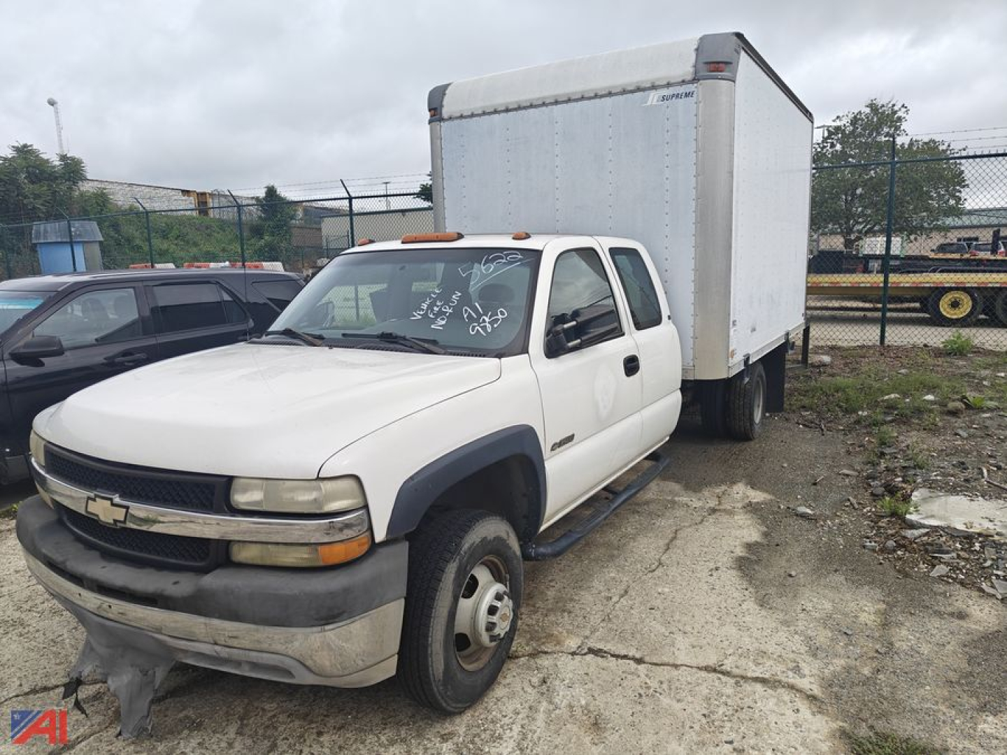 2002 Chevrolet Silverado 3500 box truck with cab and chassis, white color, side view showing box cargo area.
