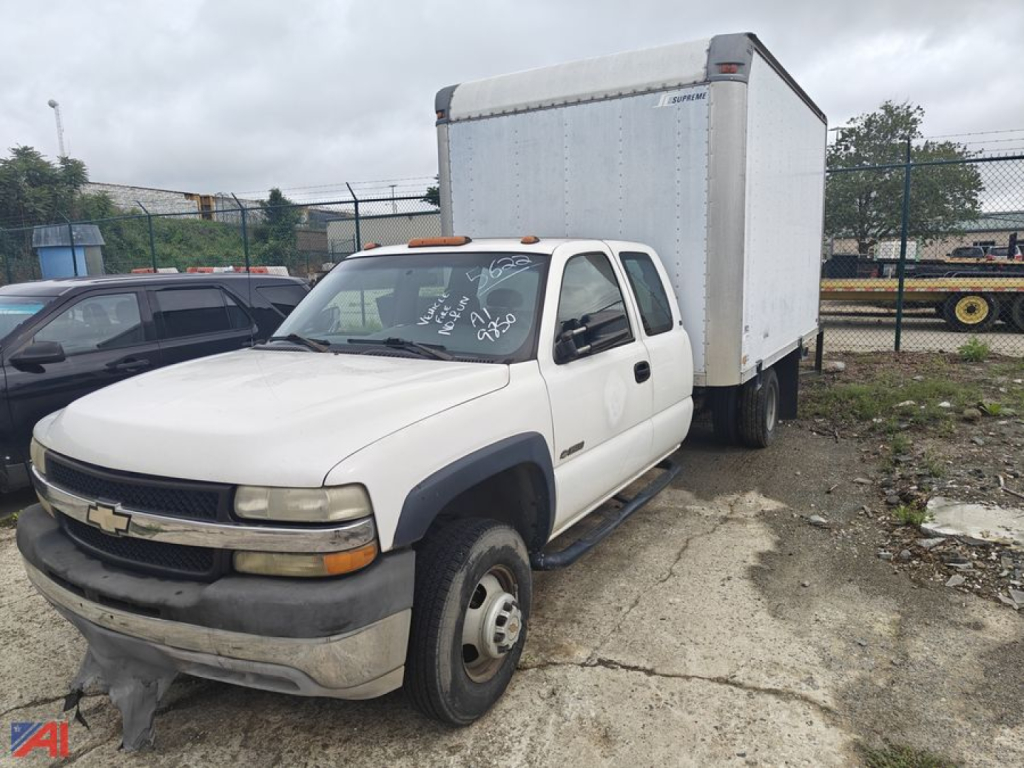 2002 Chevrolet Silverado 3500 box truck with cab and chassis, white color, side view showing box cargo area.