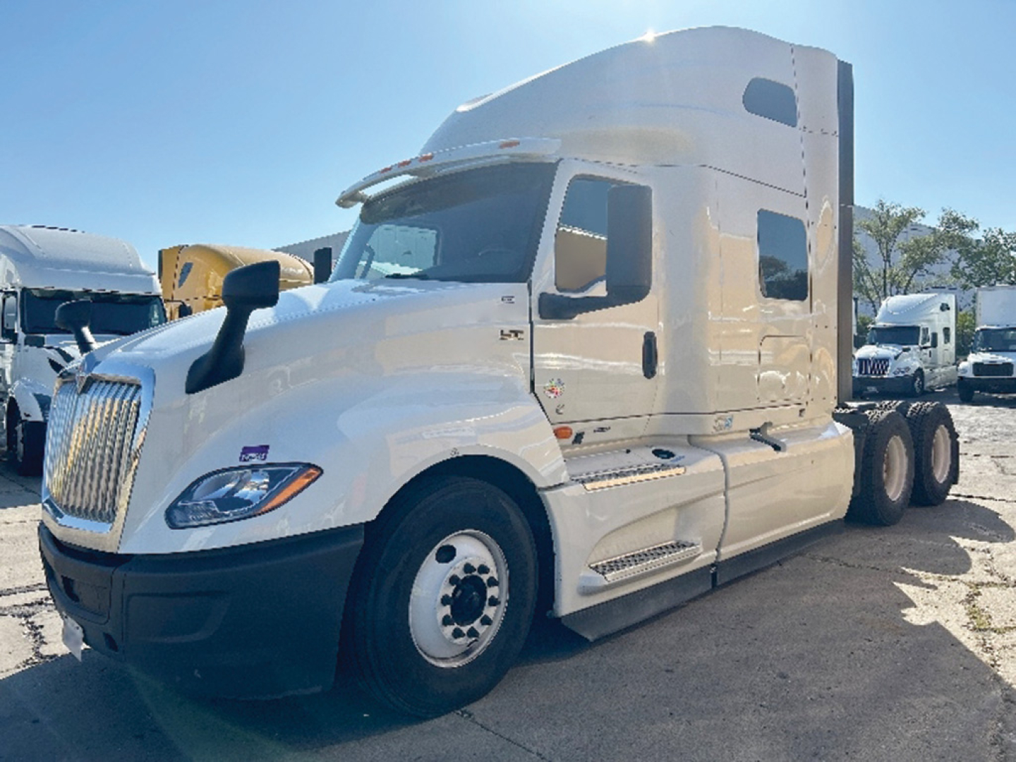 International LT625 sleeper cab truck in-service showing front-left view with white exterior and large sleeper module.