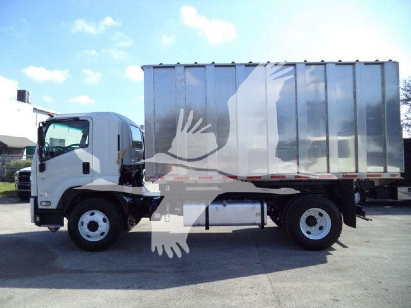Isuzu FTR trash truck with metal hopper and cab, side view showing wheel, chassis, and large dump bed.
