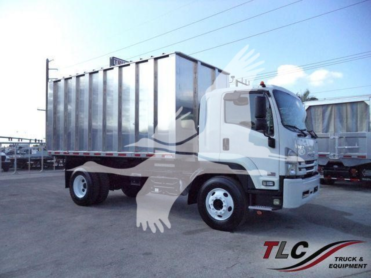 Isuzu Ftr truck with a large metal dump bed, side view showing cab and chassis, no visible text legible on the truck.