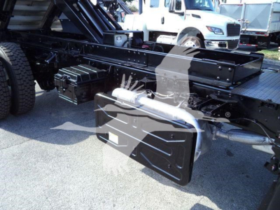 Isuzu FTR truck chassis showing undercarriage tools and fuel/air reservoirs with black metal framing and attachment boxes.
