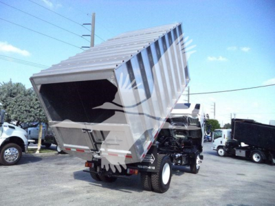 Isuzu FTR truck chassis with dump bed tilted up showing cargo bed and rear of truck