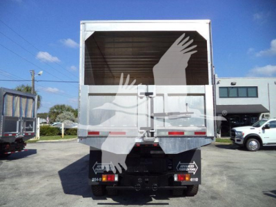 Isuzu NPR chipper truck rear view showing cargo area and tailgate with branding and rear lights.
