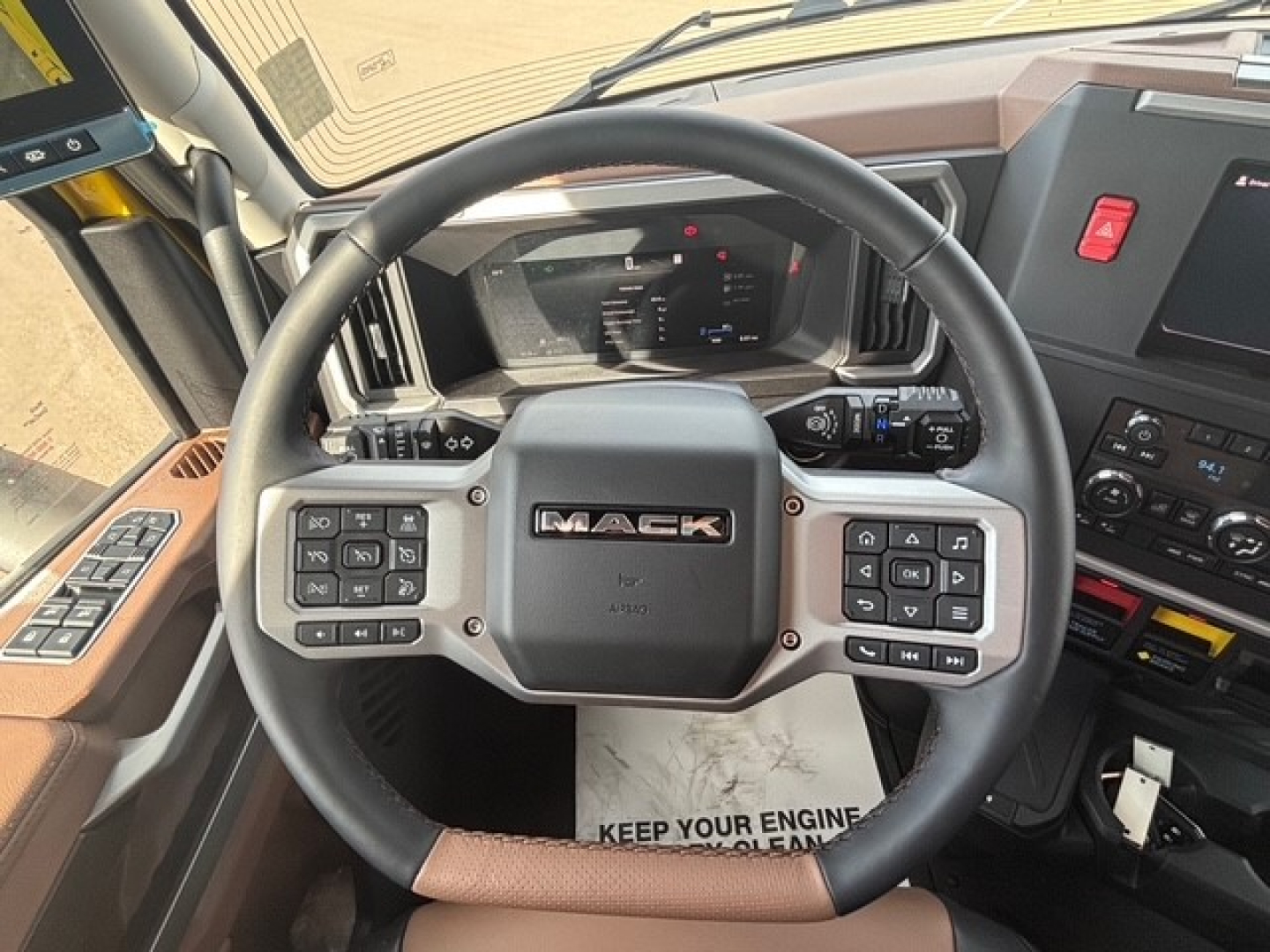 Mack PR64T76H truck steering wheel and dashboard view showing steering wheel controls and Mack logo.