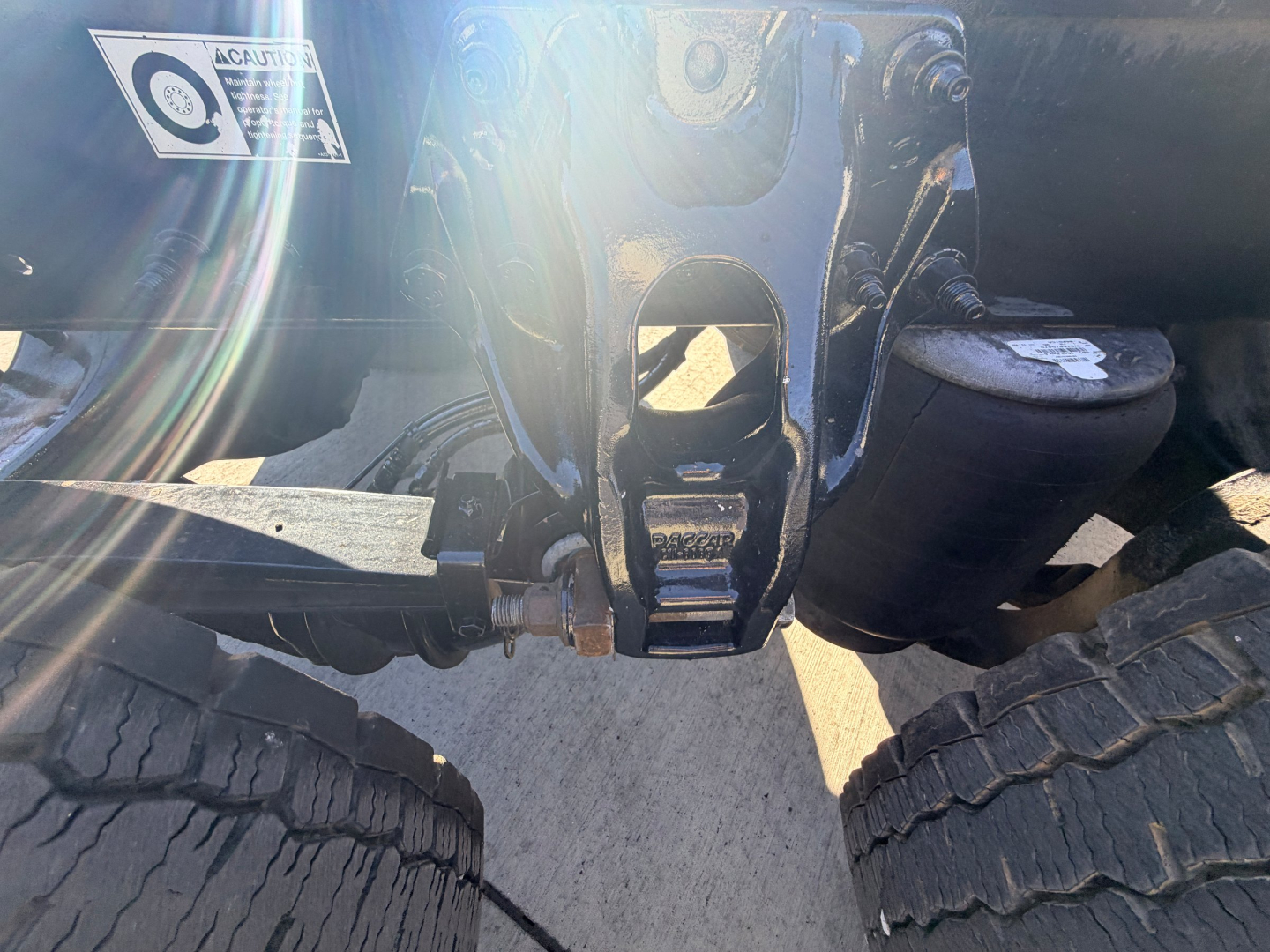 Peterbilt 567 chassis rear view showing coupling hitch and suspension area with dual rear tires visible.