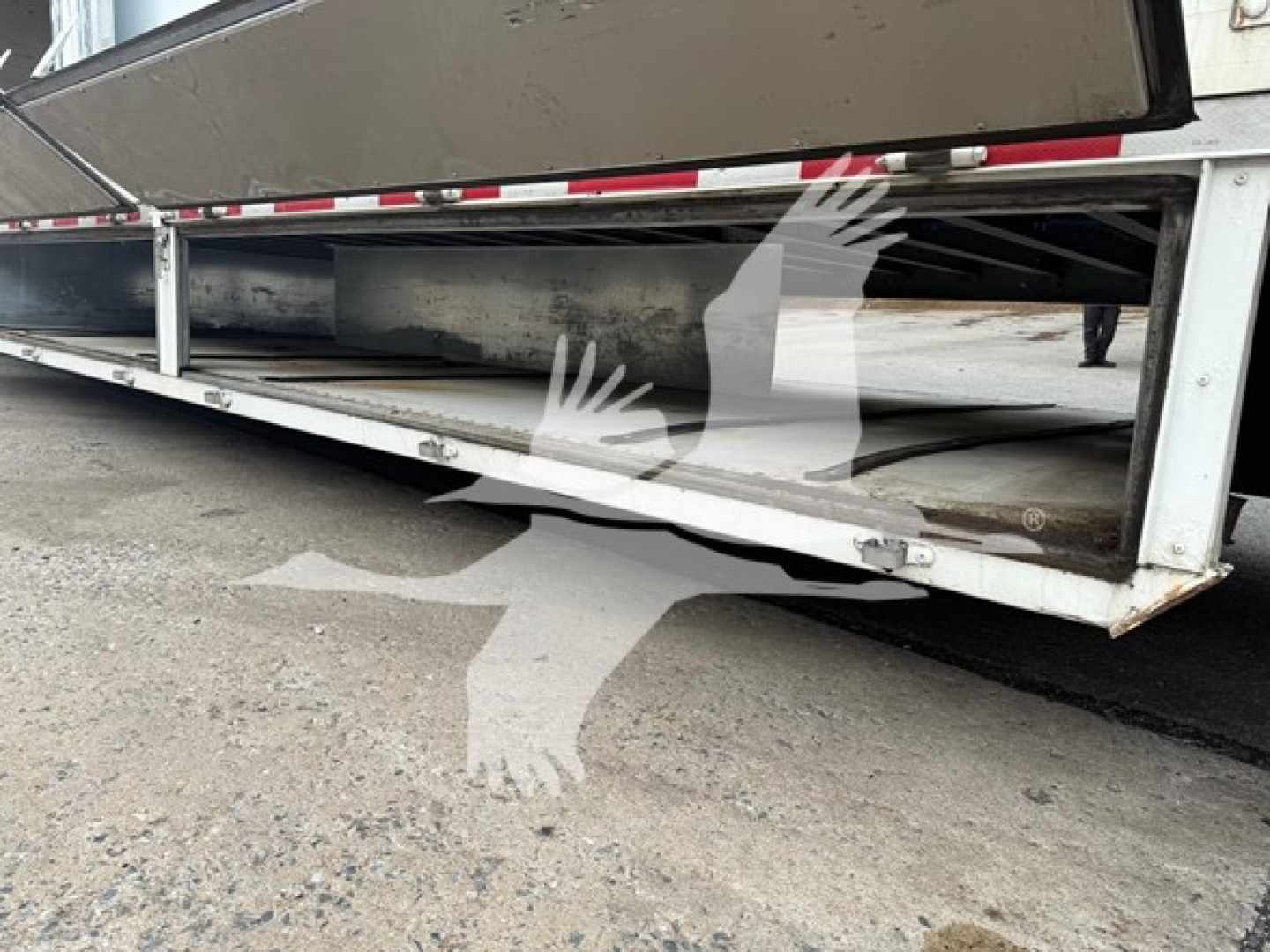 Trailer undercarriage view showing chassis rails and support beams of a 2013 Kentucky Trailer Moving Van.