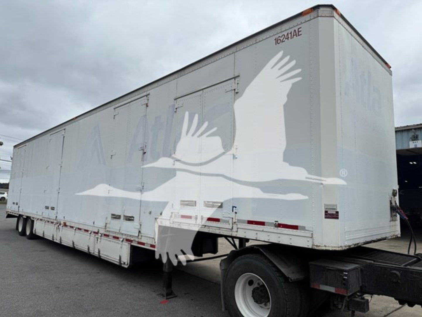 Trailer side view showing 2013 Kentucky Trailer moving van with logo eagle silhouette and stock number 7490.
