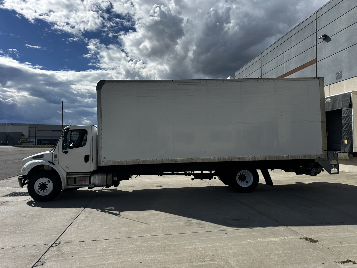 Freightliner M2-106 box truck side view showing cargo box and cab.