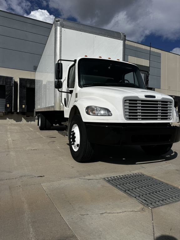 2022 Freightliner M2-106 box truck front-left view with cab and cargo box visible.