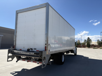 Box truck back and side view of a 2022 Freightliner M2-106 with white cargo box, dual rear wheels, and towing bumper, showing rear doors and tail lights.