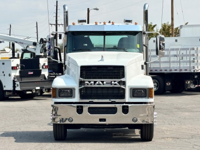 Front view of a white 2027 Mack PI64T conventional daycab truck with large grille, chrome bumper, and dual mirrors.