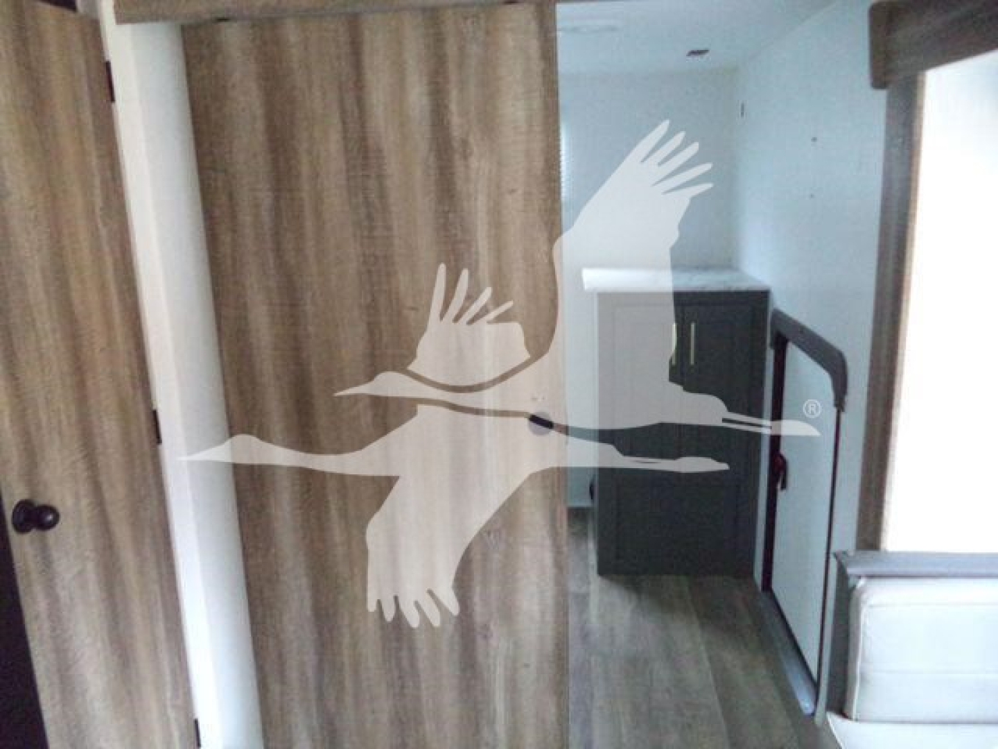 Travel trailer interior with wooden cabinetry and kitchenette visible, 2024 Unknown 322Bh model interior view