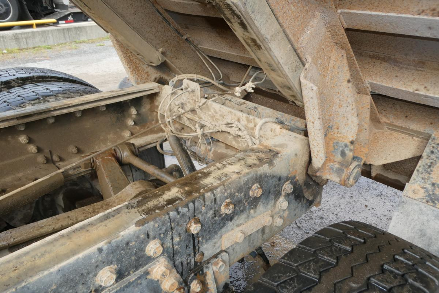 Peterbilt 357 dump truck frame and undercarriage showing rusty metal and hydraulic components.