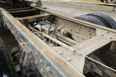 Chassis and frame rails of a Peterbilt truck showing the undercarriage with suspension and frame rails.