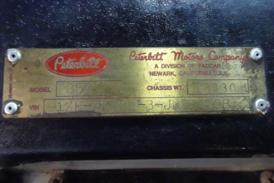 Peterbilt metal identification plate showing model 357, VIN 1XPALB0X3JN264708, chassis wt 113,330, weight label plate with Peterbilt Motors Corp branding.
