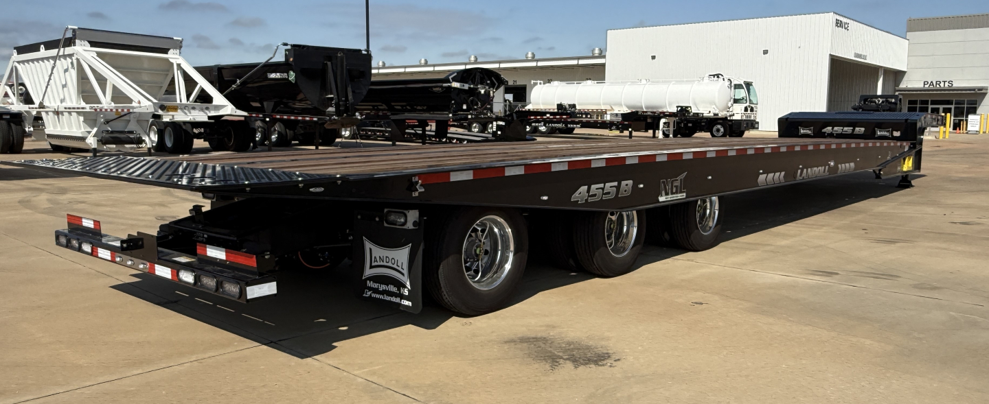 Landoll 455B-53 55 Ton Traveling Axle lowboy trailer side view showing flatbed and multiple axles.
