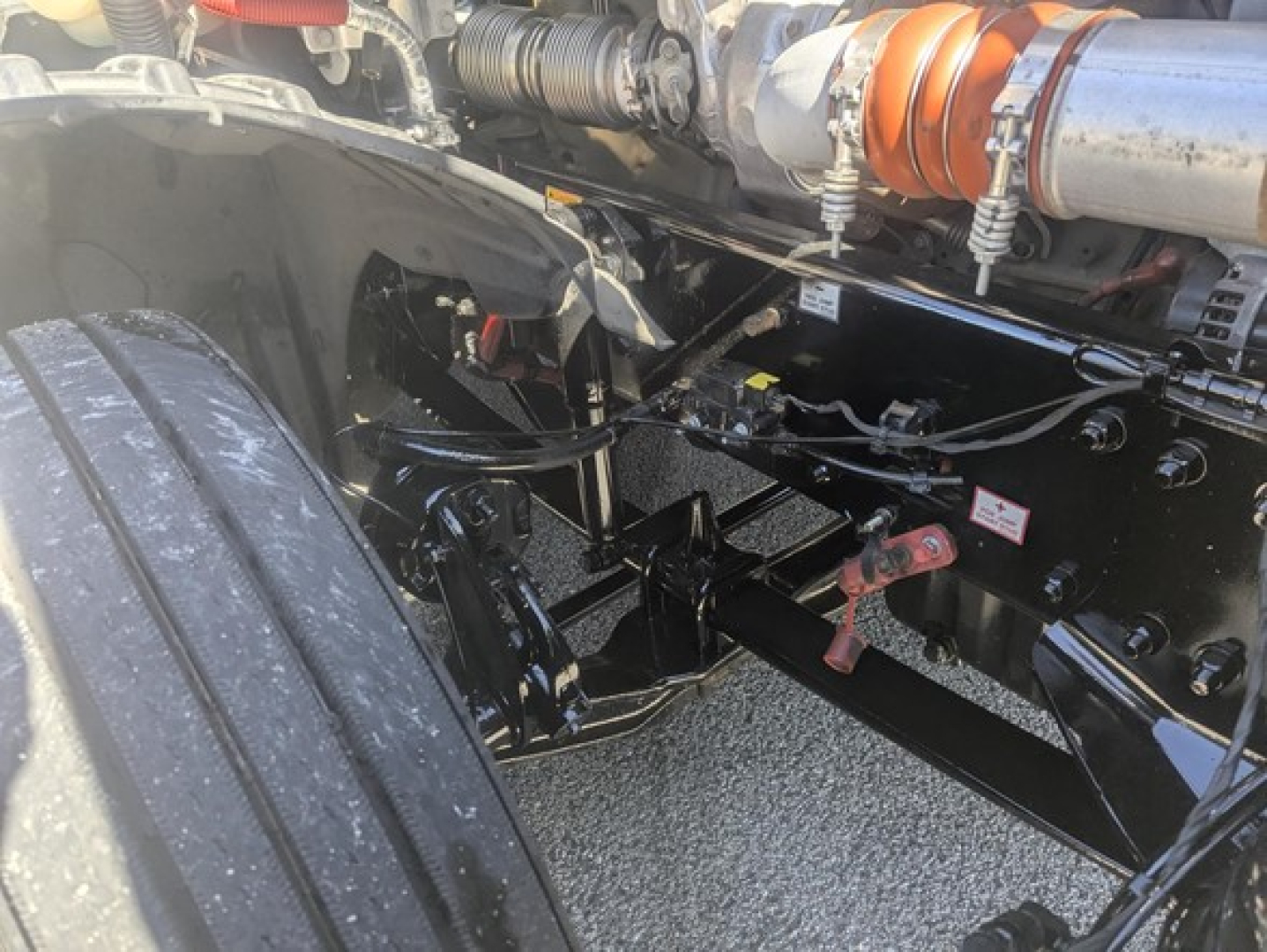 Freightliner Cascadia 126 chassis view showing suspension and cab mounting, with exposed frame rails and wiring harnesses.