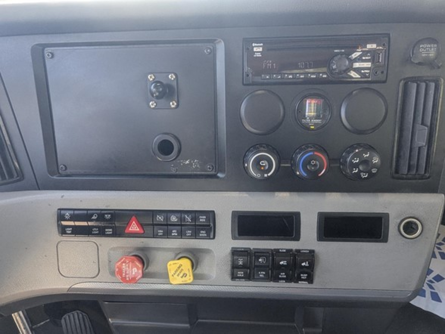 Dashboard view of a Freightliner Cascadia 126 truck showing control panels, gauges, and switches.