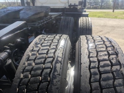 Freightliner Cascadia 126 tractor rear wheels and frame showing dual tires and suspension components.