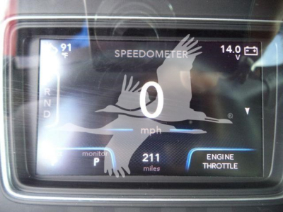 Dashboard display showing speedometer at 0 mph and engine data, with 211 miles, R N D indicators, temperature 91°F, battery voltage 14.0V, and engine throttle label.