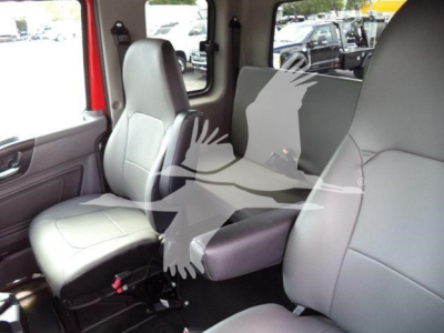 Interior of a new 2027 International MV rollback truck showing front seat and middle seat with gray upholstery.