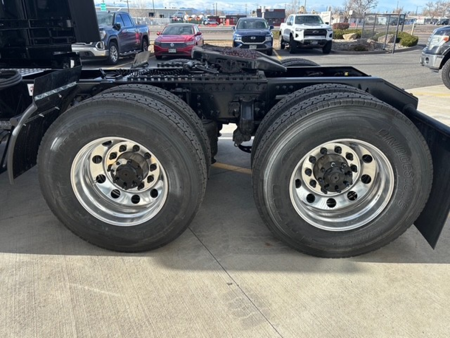 Dual rear axle on a Mack PR64T76H truck chassis showing large dual rear tires and polished wheels.