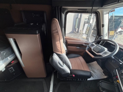 Cab interior of a 2026 Mack PR64T76H truck showing driver's seat, steering wheel, and dashboard components.