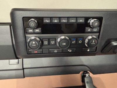 Cockpit control panel of a 2026 Mack PR64T76H sleeper truck showing HVAC control dials and infotainment buttons.