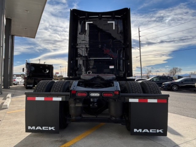 Mack PR64T76H truck rear view showing dual rear mud flaps with Mack branding and exposed fifth wheel area.