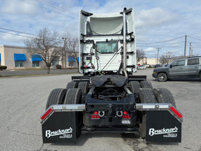 Rear view of a new 2027 Mack AN64T conventional daycab chassis showing dual rear axles, fifth wheel, and mud flaps with Bruckner’s branding.